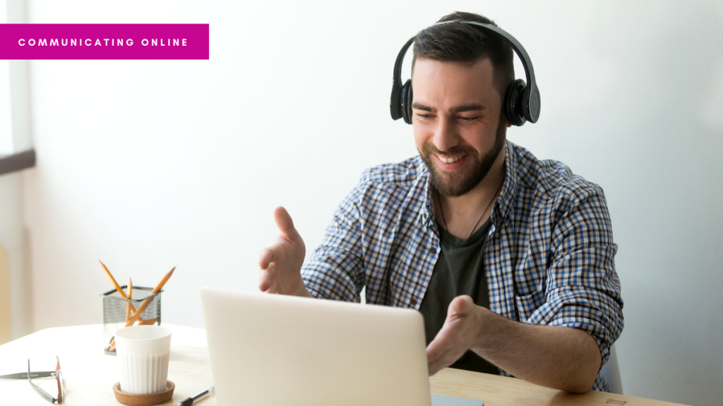 A photograph of a man presenting during an online Zoom meeting, wearing headphones. Image by Getty Images Pro