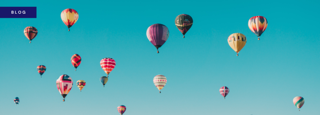 banner image showing colourful hot air balloons against a blue sky